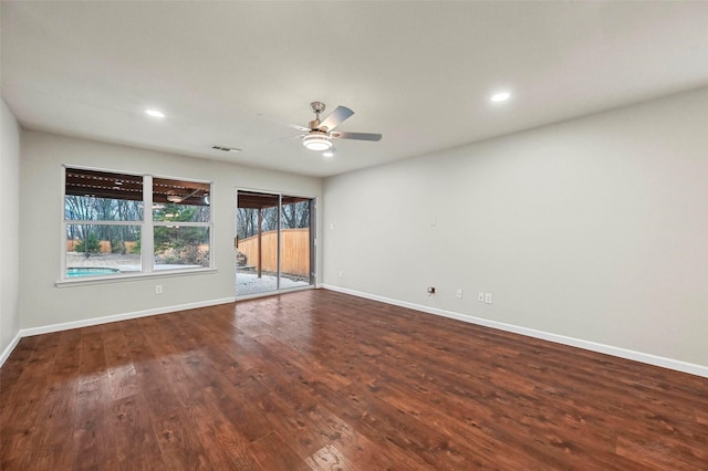 spare room with ceiling fan, wood finished floors, and baseboards