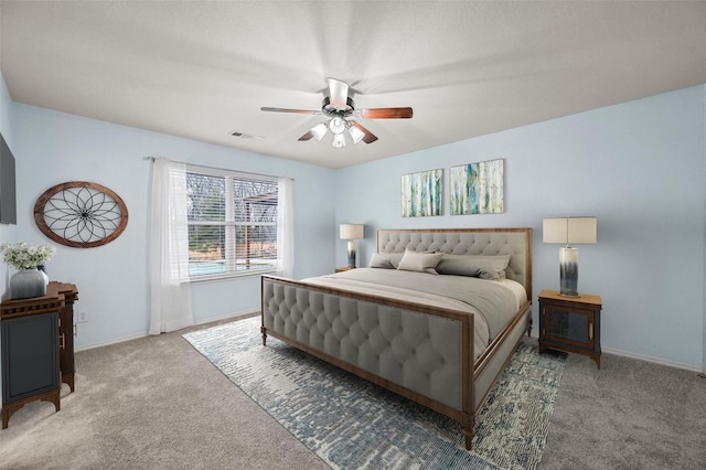 carpeted bedroom with ceiling fan, visible vents, and baseboards