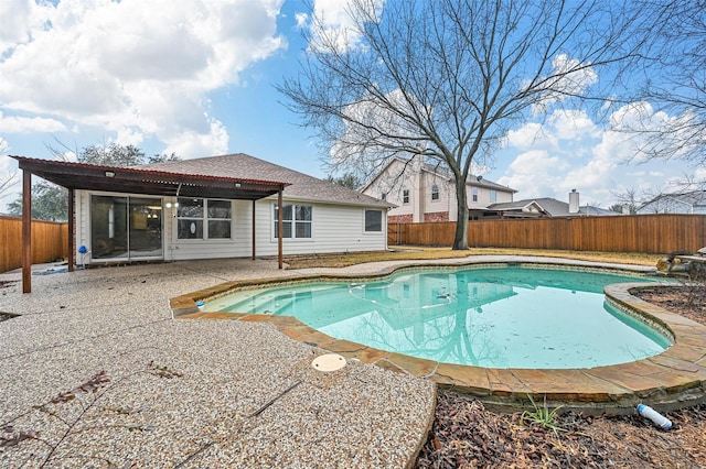 view of swimming pool with a fenced in pool, a fenced backyard, and a patio