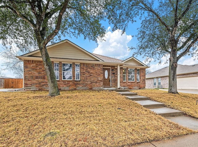 ranch-style home with brick siding and a front lawn