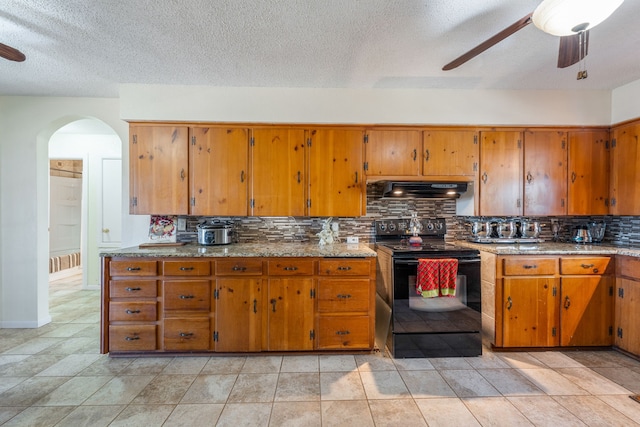 kitchen featuring ceiling fan, ventilation hood, a textured ceiling, black / electric stove, and decorative backsplash