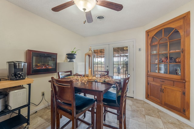 dining area with french doors and ceiling fan