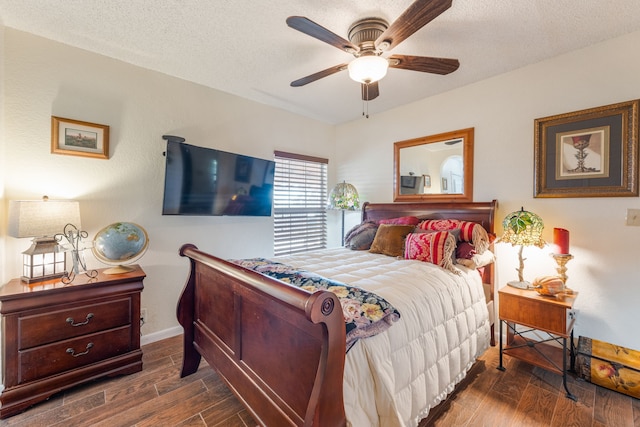 bedroom featuring ceiling fan, dark hardwood / wood-style floors, and a textured ceiling