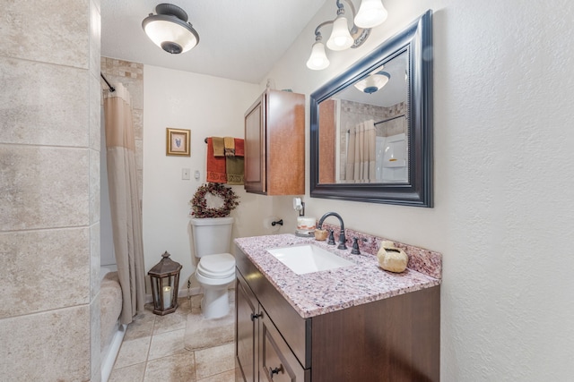 bathroom with a shower with curtain, vanity, tile patterned floors, and toilet