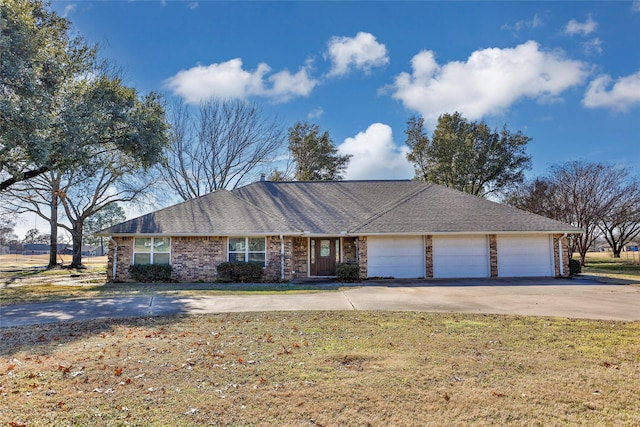 ranch-style home featuring a garage and a front lawn