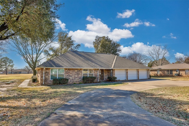 ranch-style home featuring a garage and a front yard