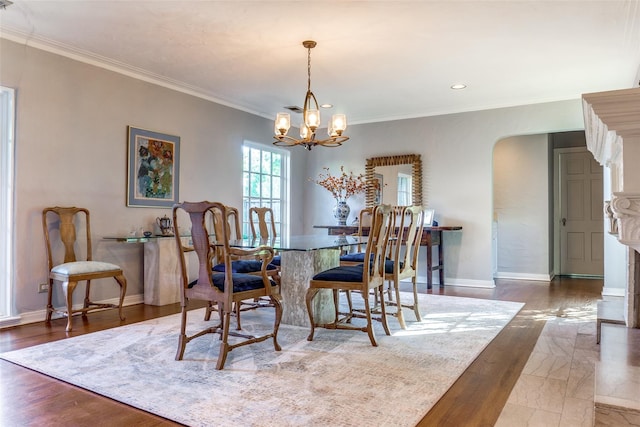 dining area featuring an inviting chandelier and crown molding