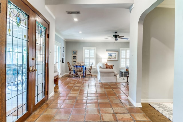 entryway featuring crown molding, ceiling fan, and french doors