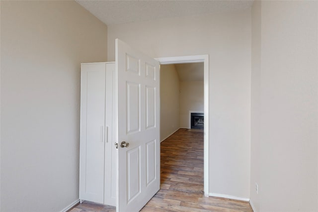 hallway featuring a textured ceiling and light wood-type flooring