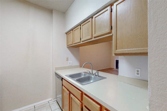 kitchen featuring light tile patterned flooring, stainless steel dishwasher, kitchen peninsula, and sink