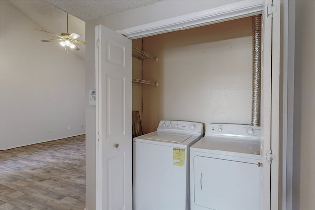 laundry room with a textured ceiling, wood-type flooring, washer and dryer, and ceiling fan