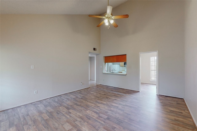 unfurnished living room featuring hardwood / wood-style flooring, high vaulted ceiling, and ceiling fan