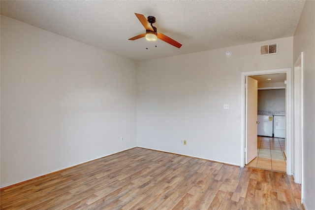 unfurnished room with ceiling fan, light hardwood / wood-style flooring, and a textured ceiling