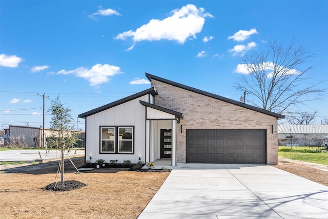 view of front of property featuring concrete driveway, an attached garage, brick siding, and board and batten siding