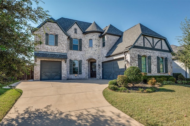 view of front of property with a garage and a front yard