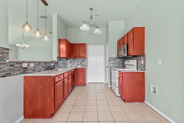 kitchen featuring pendant lighting, sink, appliances with stainless steel finishes, light tile patterned flooring, and decorative backsplash