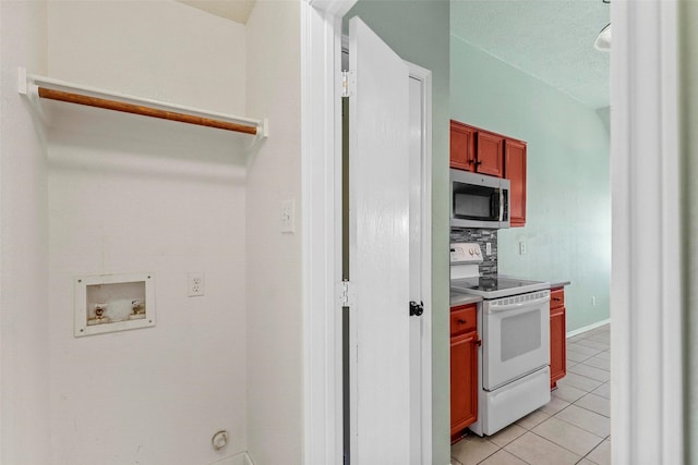 kitchen featuring light tile patterned flooring and white electric stove