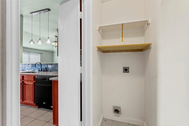 clothes washing area with light tile patterned floors, sink, and electric dryer hookup