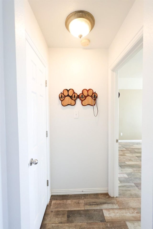 hall with wood finished floors and baseboards