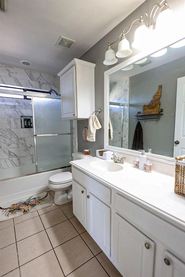 full bath featuring visible vents, toilet, combined bath / shower with glass door, tile patterned flooring, and vanity