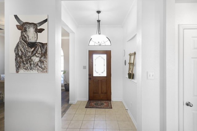 tiled entryway featuring crown molding