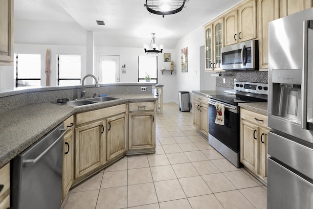 11243 Country Ridge Ln, Forney, TX 75126 - kitchen featuring light brown cabinets, a sink, decorative backsplash, light tile patterned floors, and appliances with stainless steel finishes