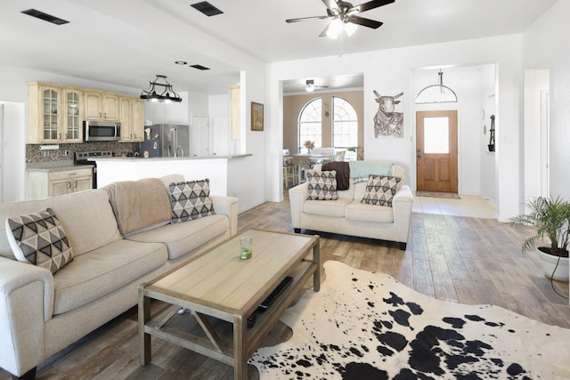 living room with ceiling fan and light hardwood / wood-style floors