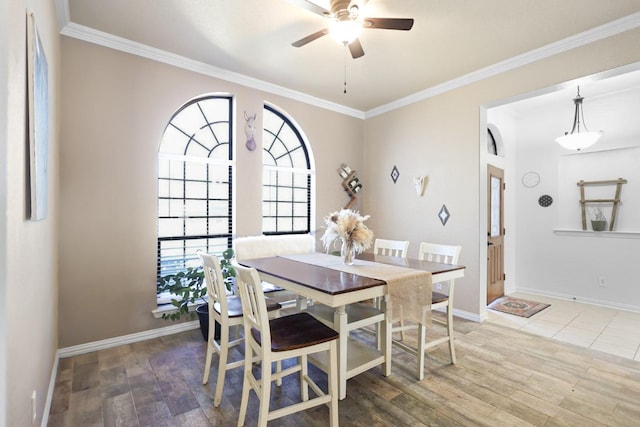 dining room with ceiling fan, ornamental molding, and wood-type flooring