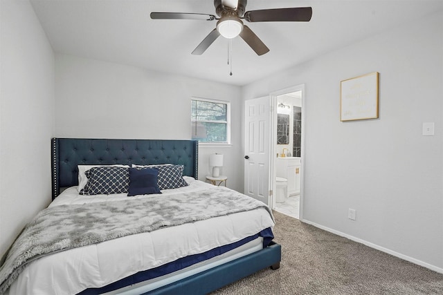 carpeted bedroom with ceiling fan and ensuite bath