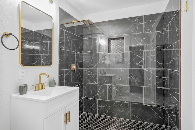 bathroom featuring vanity and tiled shower