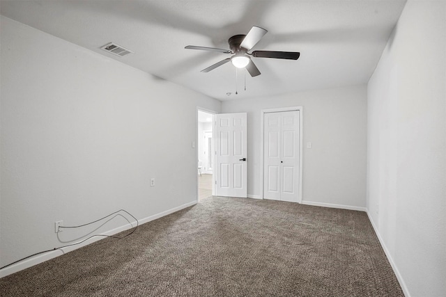 unfurnished bedroom featuring carpet, ceiling fan, and a closet