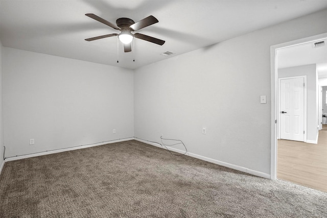 carpeted spare room with ceiling fan