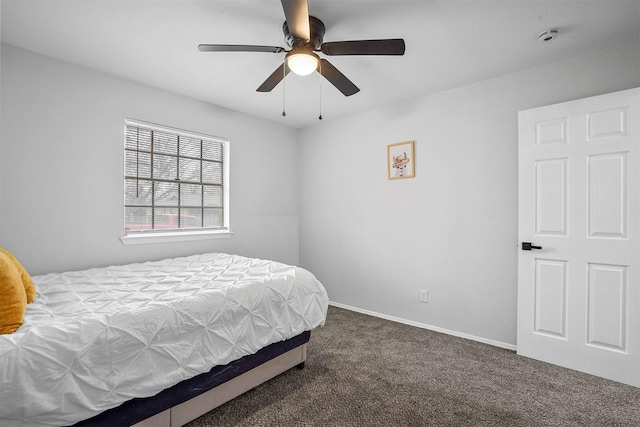 bedroom with ceiling fan and dark colored carpet