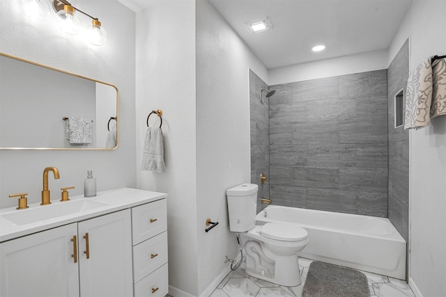 full bathroom featuring vanity, tiled shower / bath, and toilet