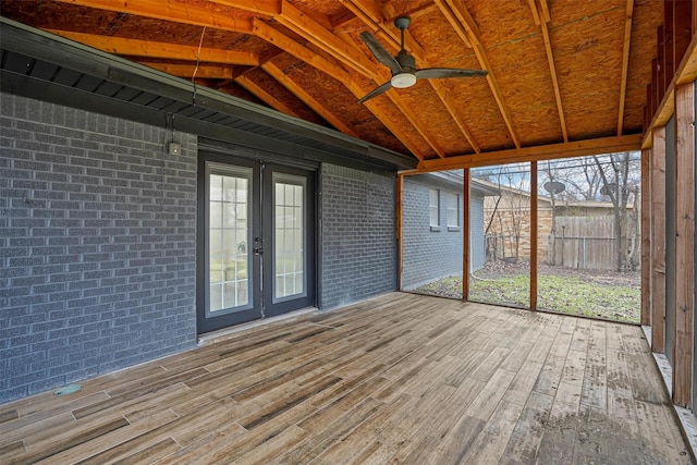 unfurnished sunroom featuring vaulted ceiling, ceiling fan, and french doors