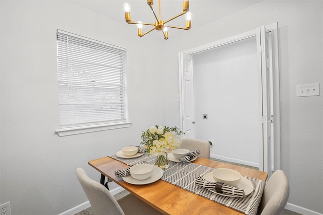 dining space featuring an inviting chandelier and hardwood / wood-style floors