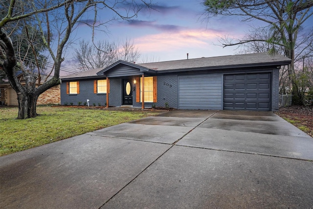 single story home with a garage and a lawn