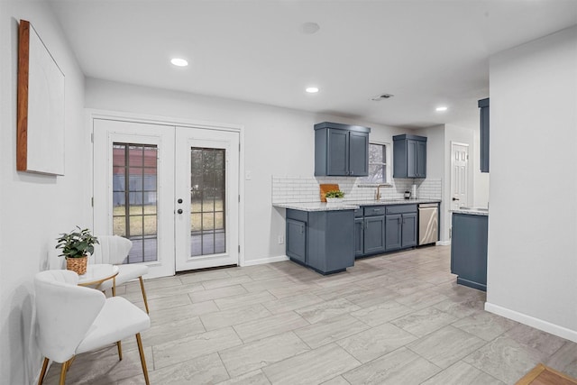 kitchen with sink, blue cabinetry, backsplash, stainless steel dishwasher, and french doors