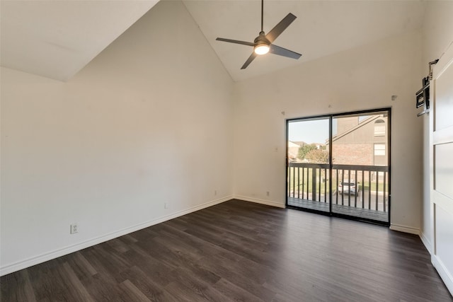 empty room featuring high vaulted ceiling, dark hardwood / wood-style floors, ceiling fan, and a barn door