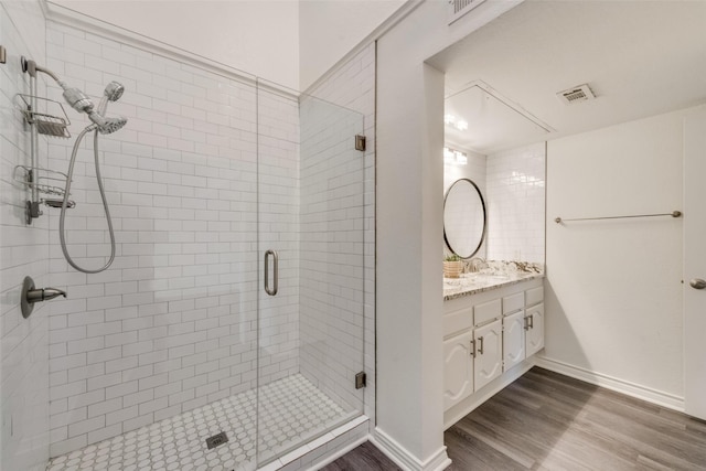 bathroom featuring vanity, hardwood / wood-style floors, and an enclosed shower