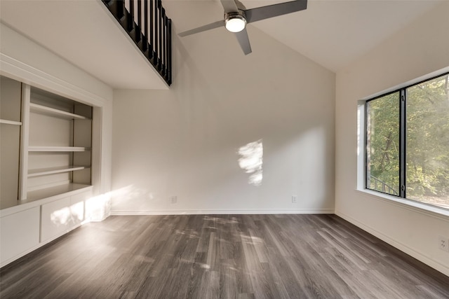 unfurnished living room featuring ceiling fan, dark hardwood / wood-style flooring, high vaulted ceiling, and built in features