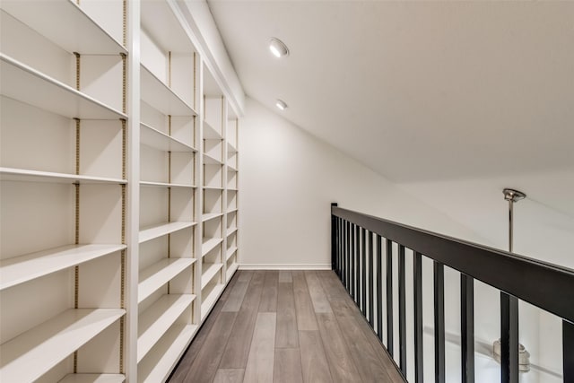 interior space with hardwood / wood-style floors and vaulted ceiling