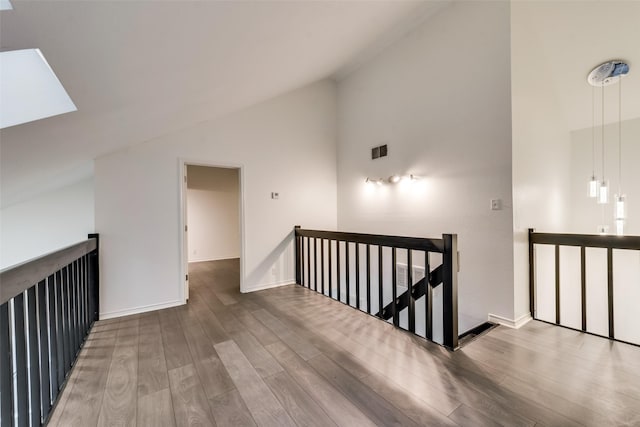 interior space featuring hardwood / wood-style flooring and high vaulted ceiling