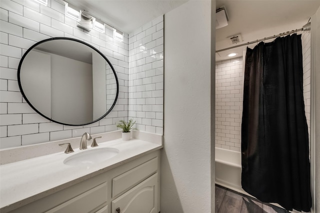 bathroom featuring tasteful backsplash, tile walls, hardwood / wood-style flooring, vanity, and shower / bath combination with curtain