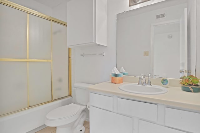 full bathroom with bath / shower combo with glass door, vanity, and toilet