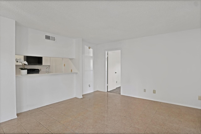 unfurnished living room with a textured ceiling