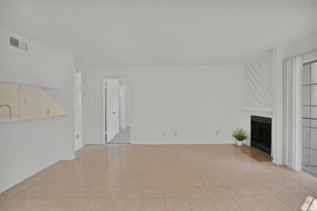 unfurnished living room featuring light tile patterned floors