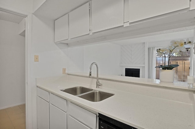 kitchen with white cabinetry, sink, and light tile patterned floors