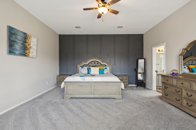 carpeted bedroom with ceiling fan and ensuite bathroom