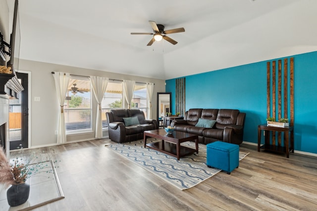 living room with lofted ceiling, wood-type flooring, and ceiling fan